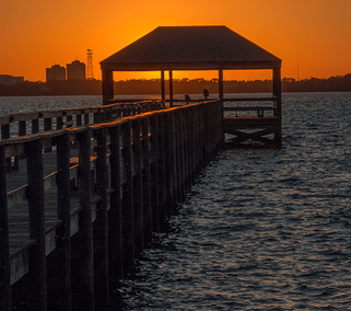 a tranquil sunset scene at the Melbourne Beach Pier in Florida.